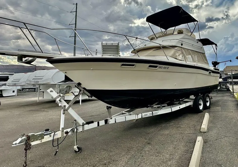 Slide: The Image of 1986 Bayliner 2850 Command Bridge on trailer under cloudy sky. - 9