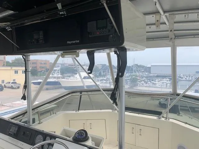 Slide: The Image of Interior view of 1988 Hatteras 48 Convertible yacht with marina background. - 13