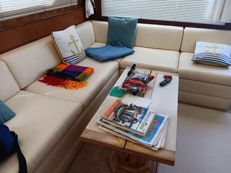Slide: The Image of Interior of 1988 Hatteras 48 Convertible yacht with cozy seating and nautical decor. - 16