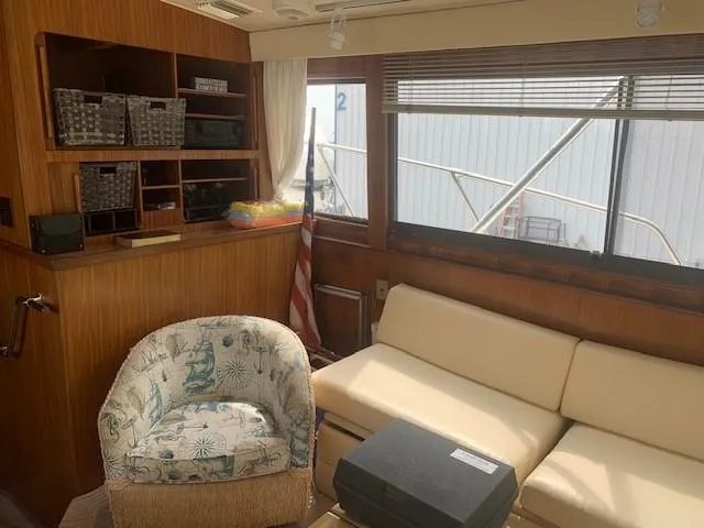 Slide: The Image of Interior of 1988 Hatteras 48 Convertible yacht with cozy seating and wooden accents. - 20