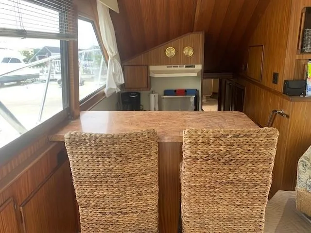 Slide: The Image of Interior of 1988 Hatteras 48 Convertible yacht with wicker chairs and wooden accents. - 21