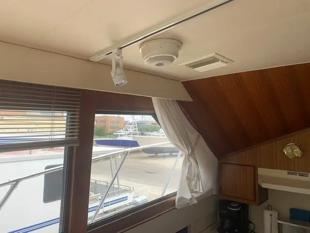 Slide: The Image of Interior view of 1988 Hatteras 48 Convertible yacht with window and wood paneling. - 22