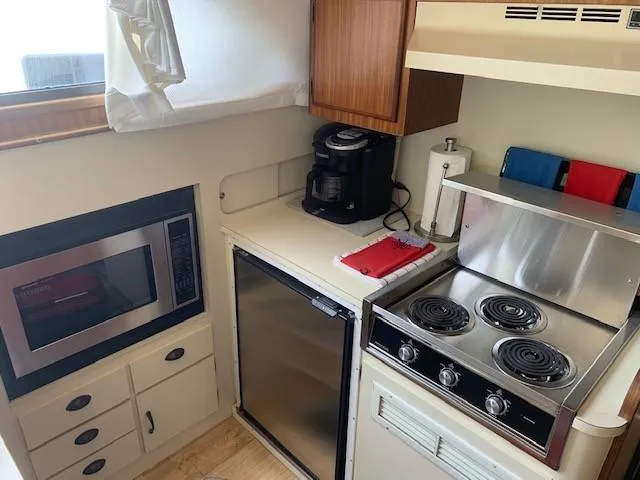 Slide: The Image of Compact kitchen in 1988 Hatteras 48 Convertible yacht with stove, fridge, and microwave. - 27