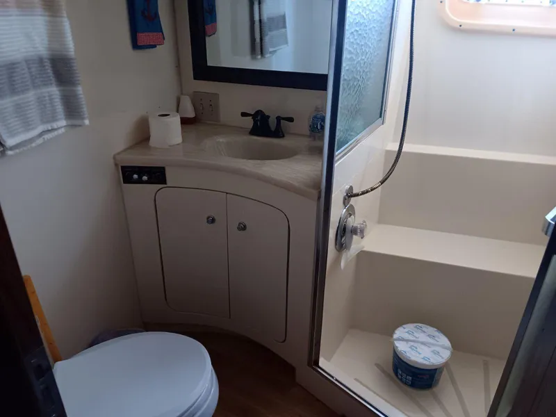 Slide: The Image of Bathroom interior of 1988 Hatteras 48 Convertible yacht with shower and sink. - 28