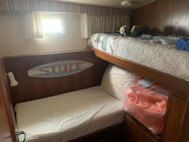 Slide: The Image of Cozy cabin interior of 1988 Hatteras 48 Convertible yacht with bunk beds and nautical decor. - 30