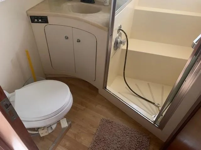 Slide: The Image of Bathroom interior of 1988 Hatteras 48 Convertible yacht with shower and toilet. - 31