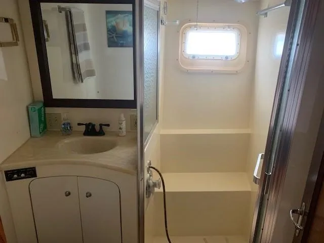 Slide: The Image of Bathroom interior of 1988 Hatteras 48 Convertible yacht with shower and sink. - 32