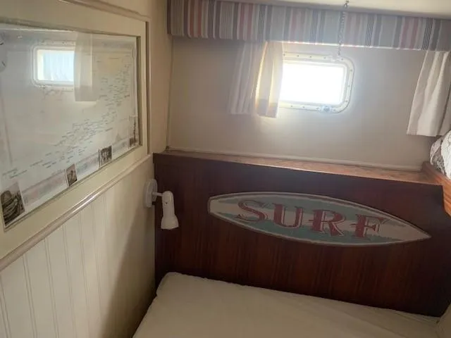 Slide: The Image of Cozy cabin interior of 1988 Hatteras 48 Convertible with nautical decor. - 33
