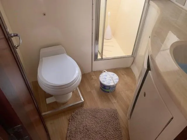 Slide: The Image of Bathroom interior of 1988 Hatteras 48 Convertible yacht with toilet and shower. - 34