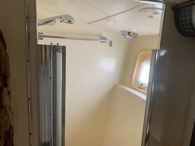 Slide: The Image of Shower area in 1988 Hatteras 48 Convertible yacht with window and chrome fixtures. - 35