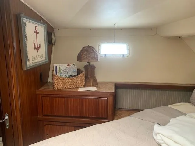 Slide: The Image of Cozy cabin interior of 1988 Hatteras 48 Convertible yacht with nautical decor. - 36