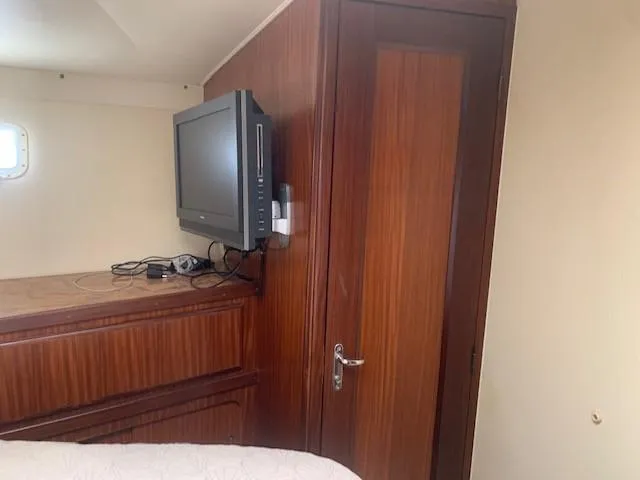 Slide: The Image of Interior of 1988 Hatteras 48 Convertible with TV and wooden cabinetry. - 37