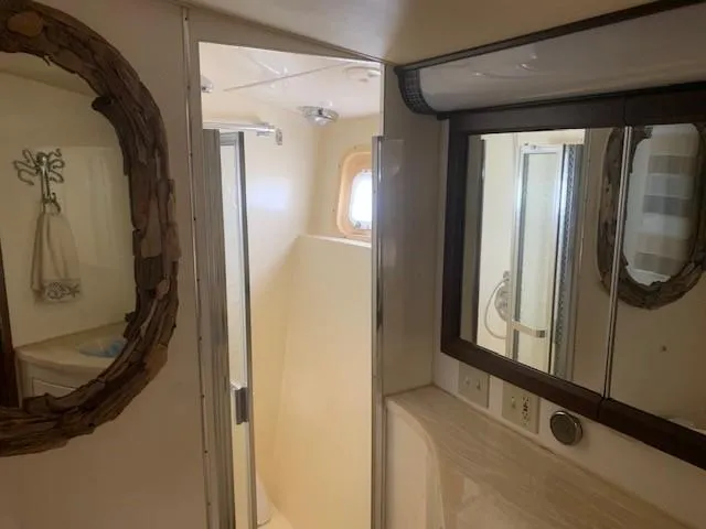 Slide: The Image of Bathroom interior of 1988 Hatteras 48 Convertible yacht with mirror and shower. - 38