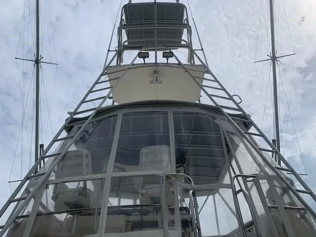 Slide: The Image of 1988 Hatteras 48 Convertible yacht, view of the flybridge and tower against cloudy sky. - 4