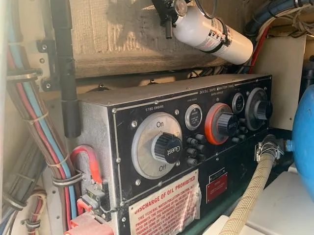 Slide: The Image of Control panel in 1988 Hatteras 48 Convertible engine room with fire extinguisher. - 40