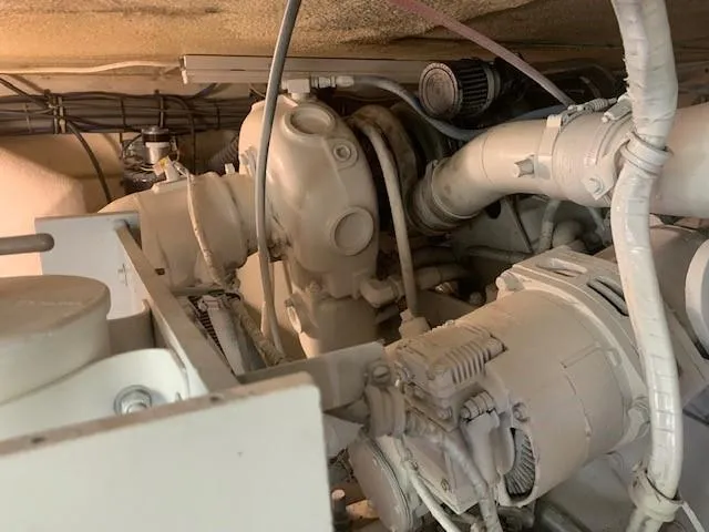 Slide: The Image of Engine compartment of 1988 Hatteras 48 Convertible boat, showcasing mechanical components. - 43