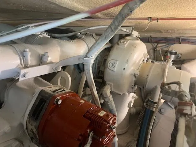 Slide: The Image of Engine room of 1988 Hatteras 48 Convertible yacht with visible machinery and components. - 44