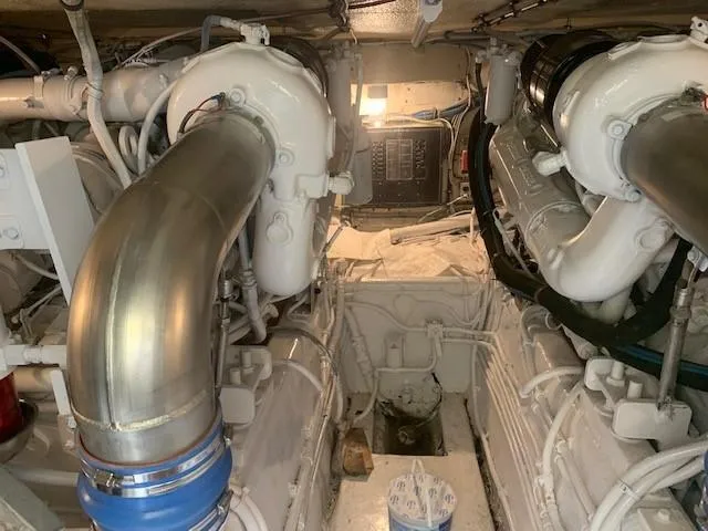 Slide: The Image of Engine room of 1988 Hatteras 48 Convertible yacht, showcasing dual engines and mechanical components. - 47