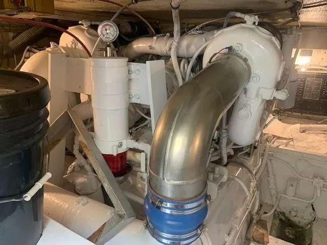 Slide: The Image of Engine room of 1988 Hatteras 48 Convertible yacht, showcasing mechanical components. - 49