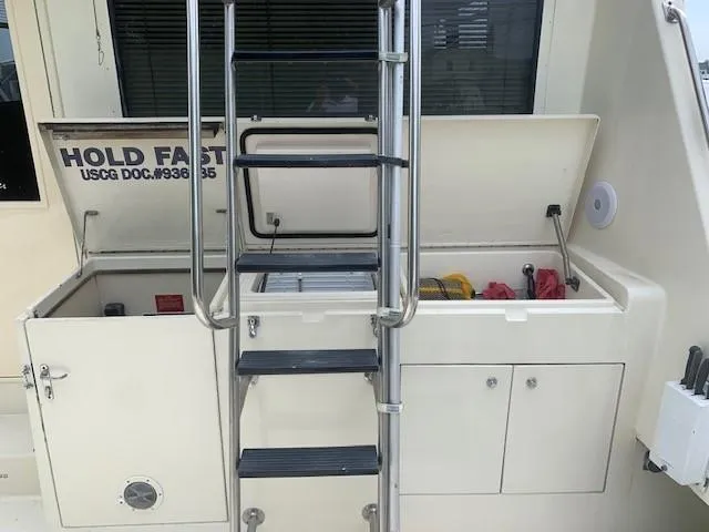 Slide: The Image of 1988 Hatteras 48 Convertible boat deck with ladder and storage compartments. - 5