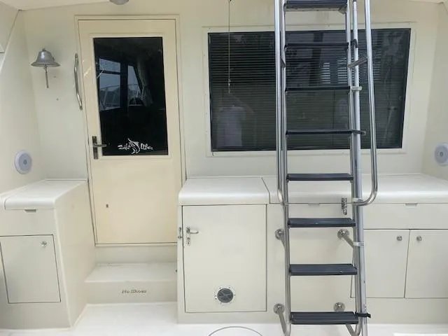 Slide: The Image of 1988 Hatteras 48 Convertible yacht deck with ladder and storage compartments. - 6