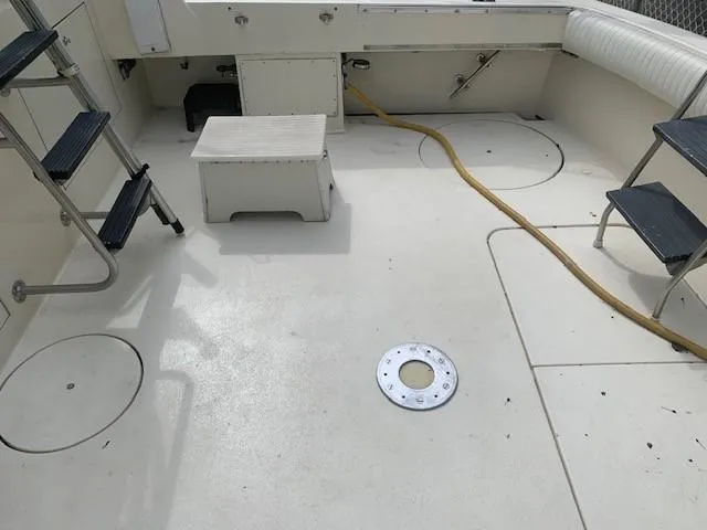 Slide: The Image of 1988 Hatteras 48 Convertible boat deck with ladder and seating area. - 7