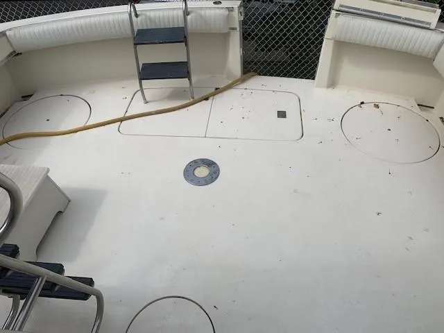 Slide: The Image of 1988 Hatteras 48 Convertible boat deck with seating and ladder. - 8