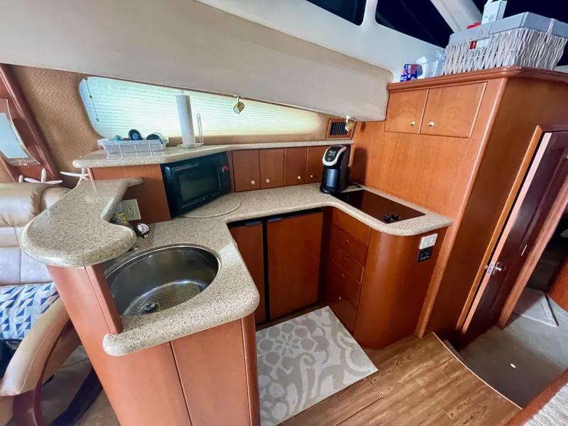 Slide: The Image of 2006 Silverton 43 Sport Bridge yacht kitchen with modern appliances and wood cabinetry. - 10