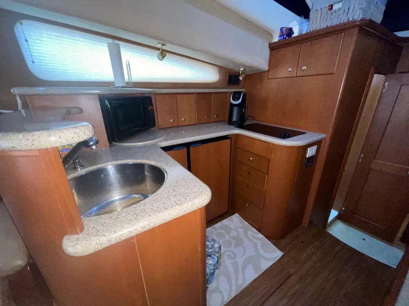 Slide: The Image of 2006 Silverton 43 Sport Bridge kitchen with wood cabinetry and modern appliances. - 11