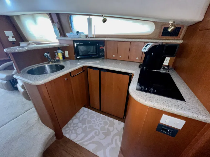Slide: The Image of Interior of 2006 Silverton 43 Sport Bridge yacht kitchen with modern appliances. - 13