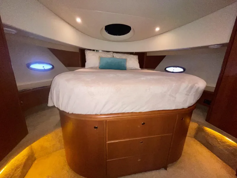 Slide: The Image of Luxurious bedroom in 2006 Silverton 43 Sport Bridge yacht with elegant wood cabinetry. - 15