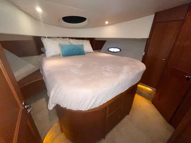 Slide: The Image of Luxurious bedroom interior of 2006 Silverton 43 Sport Bridge yacht with cozy bed and ambient lighting. - 21