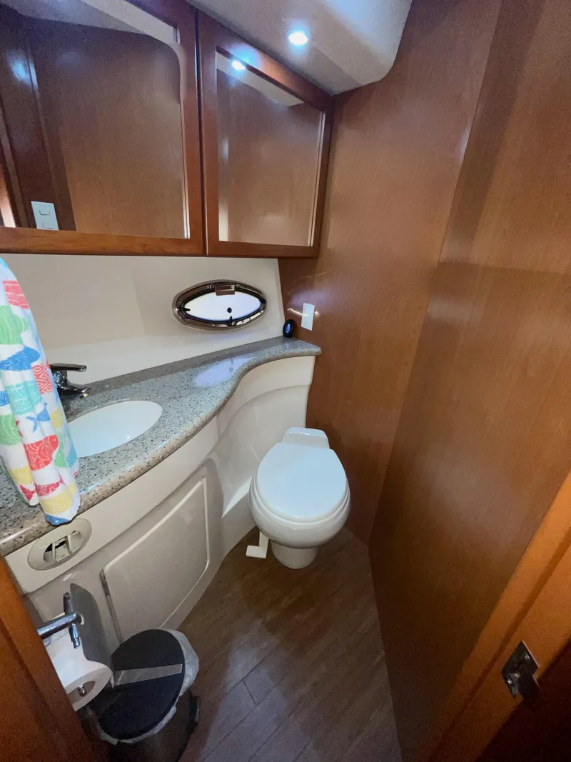 Slide: The Image of 2006 Silverton 43 Sport Bridge bathroom with wood accents and modern fixtures. - 25