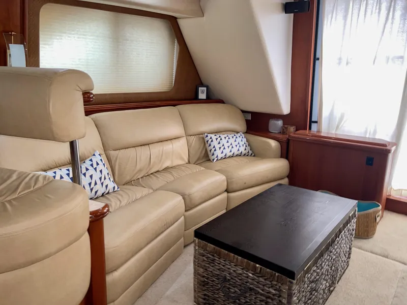 Slide: The Image of Luxurious interior of 2006 Silverton 43 Sport Bridge with beige leather seating and modern decor. - 3