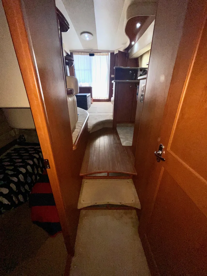 Slide: The Image of Interior view of 2006 Silverton 43 Sport Bridge yacht, featuring wooden steps and cozy cabin. - 30