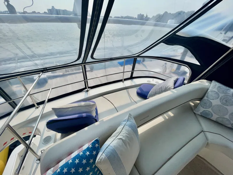 Slide: The Image of Interior view of 2006 Silverton 43 Sport Bridge yacht with plush seating and scenic water backdrop. - 33