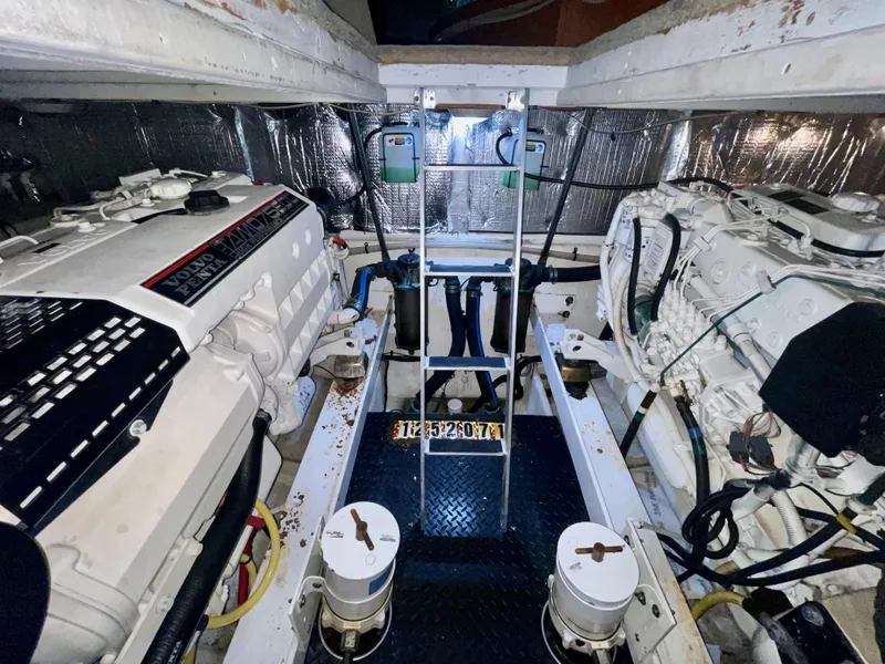Slide: The Image of Engine room of 2006 Silverton 43 Sport Bridge with dual engines and ladder access. - 41
