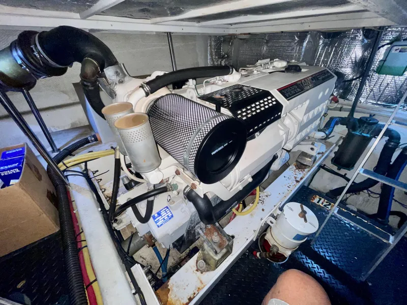 Slide: The Image of Engine room of a 2006 Silverton 43 Sport Bridge yacht, showcasing the engine and components. - 42