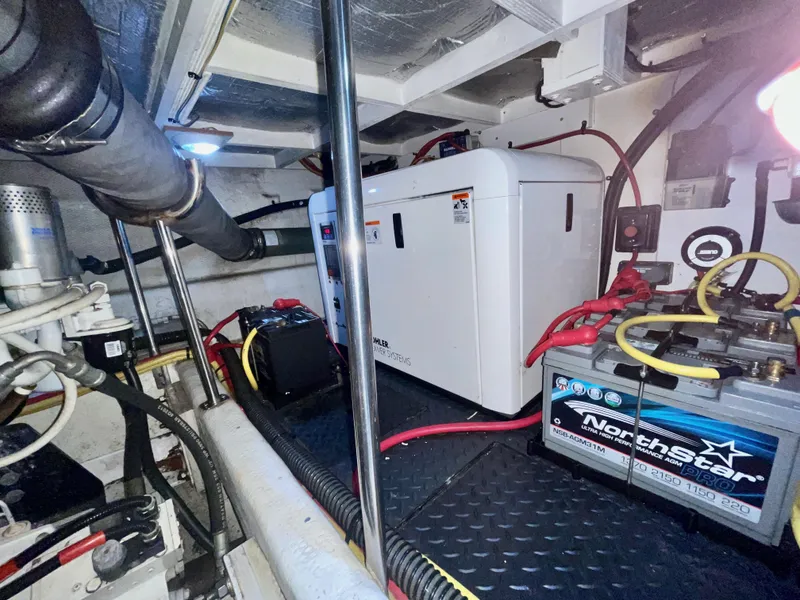 Slide: The Image of Engine room of 2006 Silverton 43 Sport Bridge with generator and battery. - 43