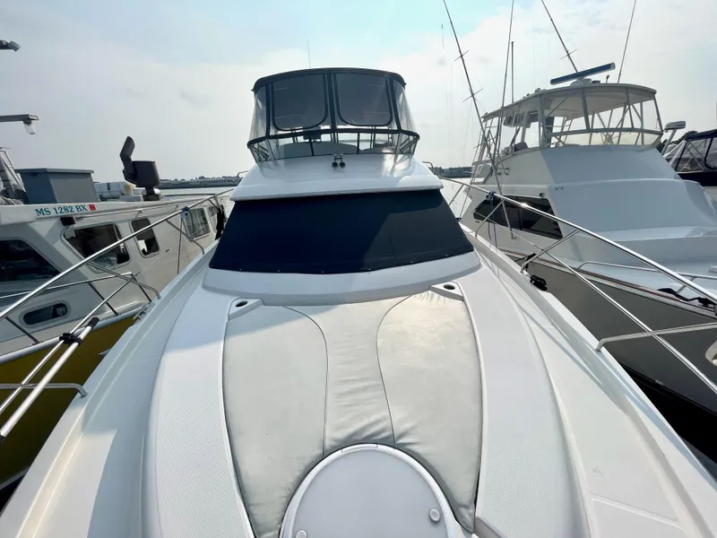 Slide: The Image of 2006 Silverton 43 Sport Bridge yacht docked at marina. - 44