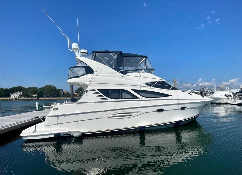Slide: The Image of 2006 Silverton 43 Sport Bridge yacht docked on a sunny day. - 48