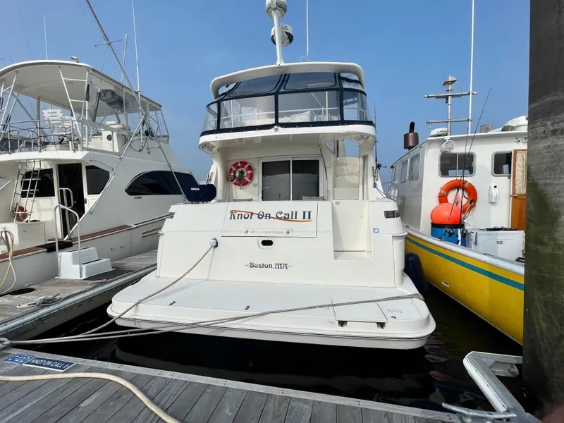 Slide: The Image of 2006 Silverton 43 Sport Bridge yacht docked at marina, rear view. - 49