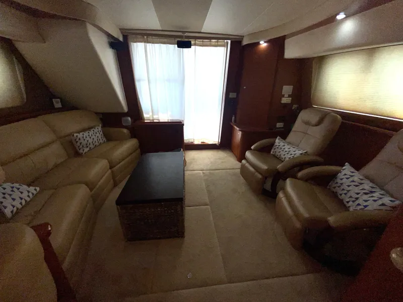 Slide: The Image of Luxurious interior of 2006 Silverton 43 Sport Bridge yacht with plush seating and elegant decor. - 5