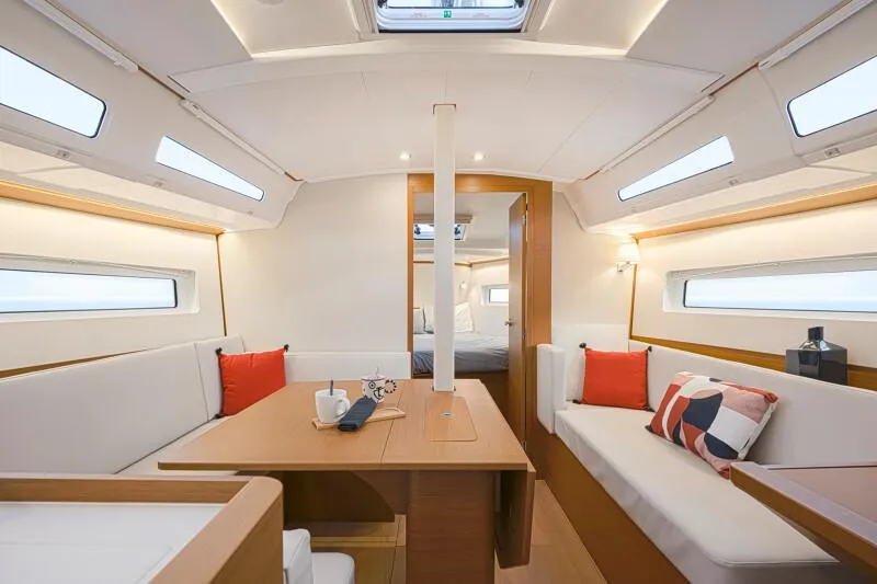 Slide: The Image of Interior of 2025 Jeanneau 380 sailboat, featuring modern seating and dining area. - 6
