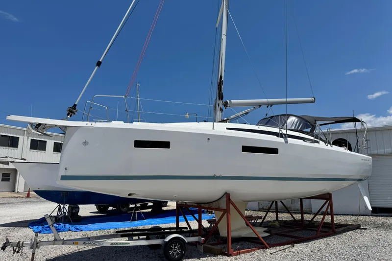 The Image of 2025 Jeanneau Sun Odyssey 380 sailboat on trailer, displayed outdoors under clear blue sky. - 0