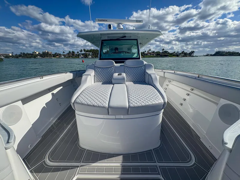 Slide: The Image of 2024 HCB 53' Suenos luxury boat with plush seating on a sunny day. - 31