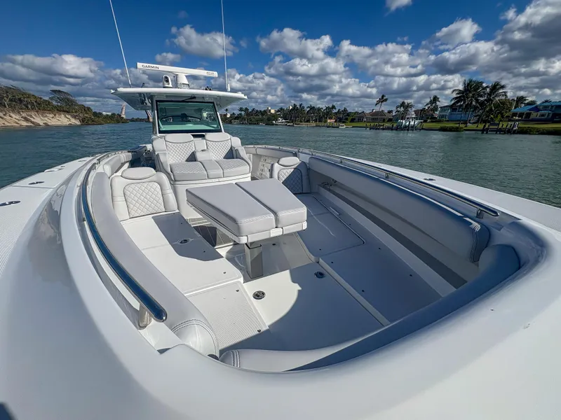 Slide: The Image of 2024 HCB 53' Suenos luxury boat with spacious seating, cruising on a sunny day. - 34