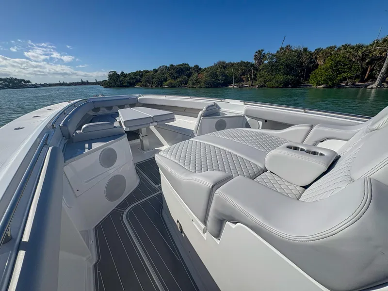 Slide: The Image of Luxurious 2024 HCB 53' Suenos boat interior with plush seating and scenic water view. - 38