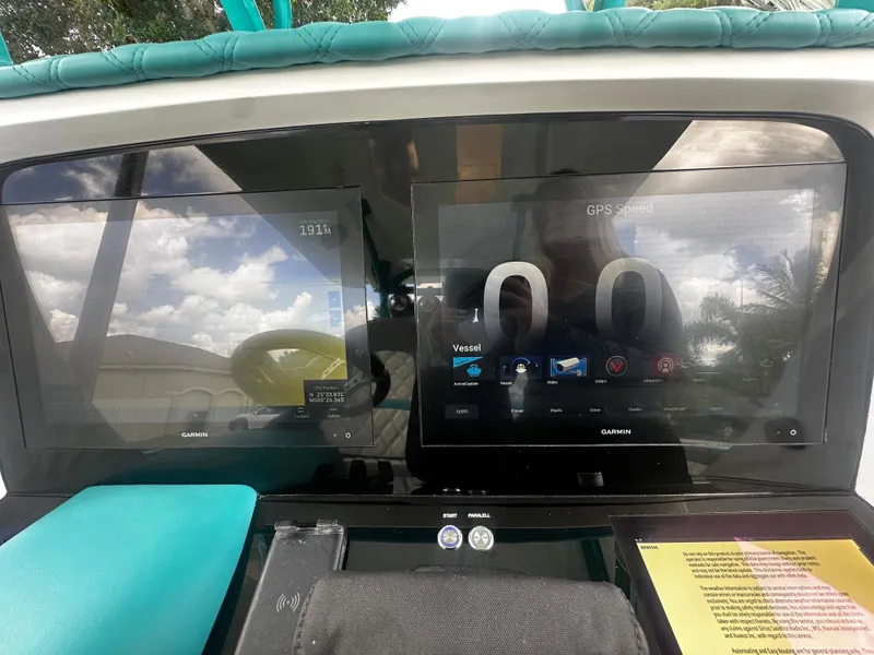 Slide: The Image of 2021 Renegade 38 Open dashboard with dual Garmin displays and GPS speedometer. - 16