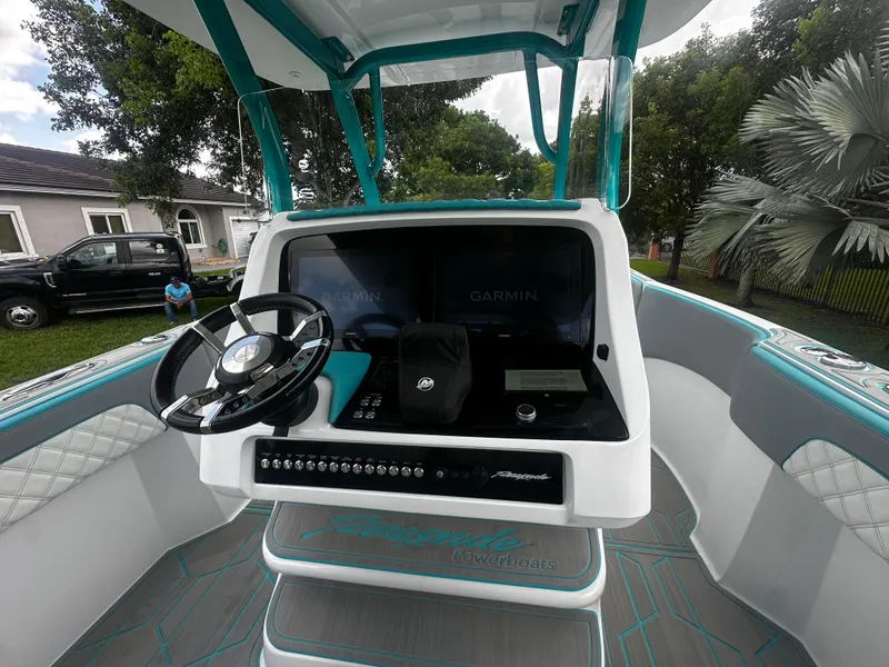 Slide: The Image of 2021 Renegade 38 Open boat dashboard with steering wheel and Garmin navigation system. - 18